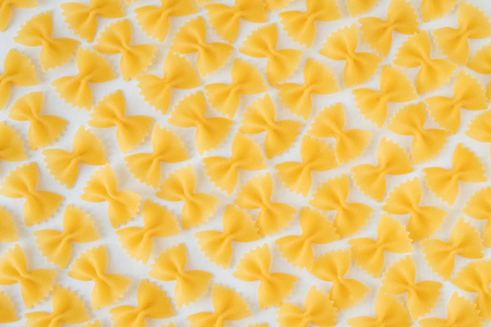 Uncooked italian pasta on a white backgroundの写真素材