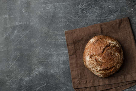 Rustic bread of whole wheat grains on dark background with copy space. Flat lay.の写真素材