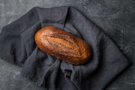 Rustic bread on dark background. Flat lay.の写真素材