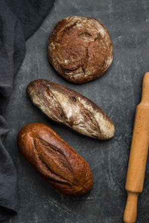 Rustic bread on dark background. Flat lay.の写真素材