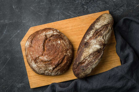 Rustic bread on dark background. Flat lay.の写真素材