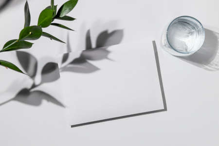 Summer wedding stationery mock-up scene with a glass of water. Blank greeting card, craft paper...