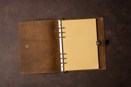 open brown leather diary on brown background or table .. start life from scratch.の写真素材