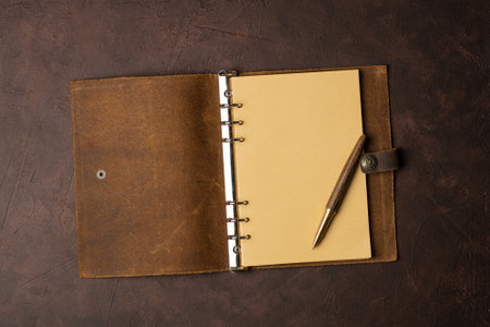 open brown leather diary on brown background or table .. start life from scratch.の写真素材