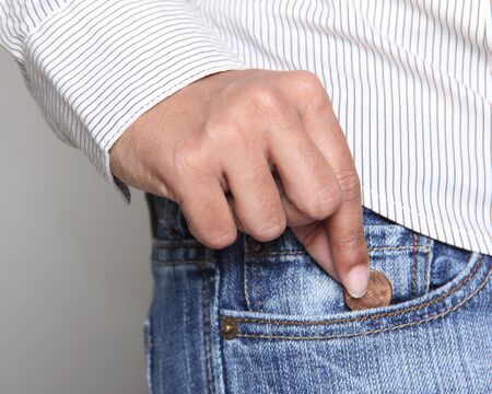 Bankruptcy - Person taking a penny from her jean pocket