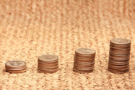 Growth - stacks of coins on a matの写真素材