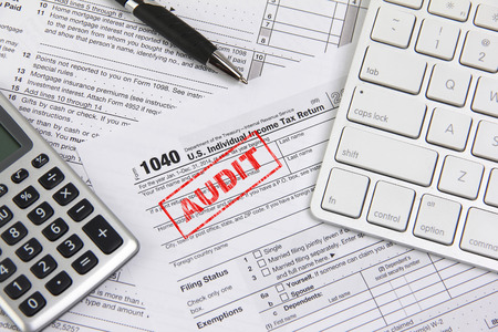 Filing taxes online using a computer and being auditedの写真素材