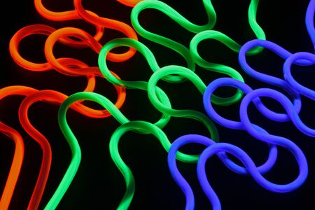 Plastic straws under black lightの写真素材