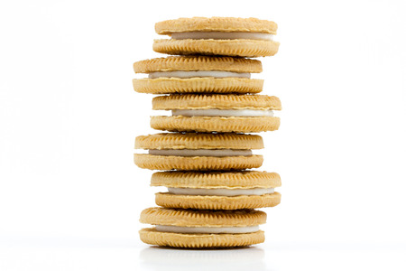 Stack of Vanilla cookies with cream filling on white background