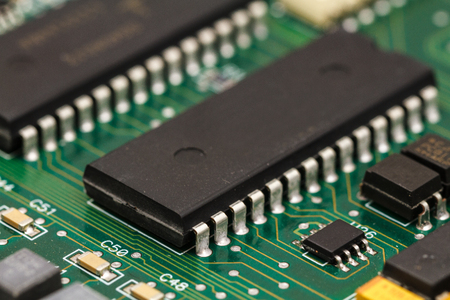 Printed circuit board with ICs, chip capacitors, and chip resistors.