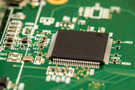 Printed circuit board with ICs, chip capacitors, and chip resistors.