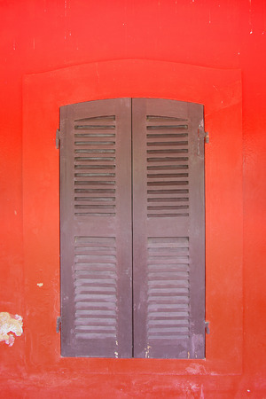 the window on red wallの写真素材