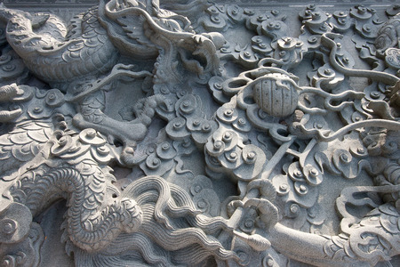 Chinese dragons on granite wall textureの写真素材