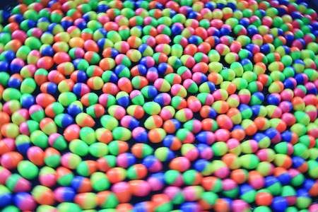 colorful plastic eggs floating on the water backgroundの写真素材