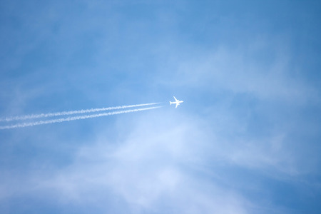 A long trail of jet plane on blue skyの写真素材