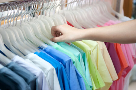 Colorful t-shirt on hangersの写真素材