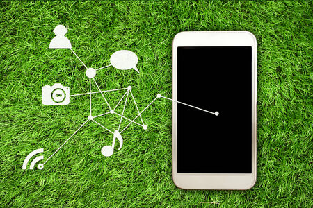 smartphone on grass backgroundの写真素材