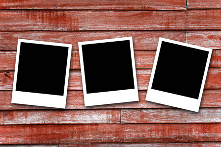 Blank photo frames on wood backgroundの写真素材