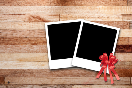 Blank photo frames on wood backgroundの写真素材