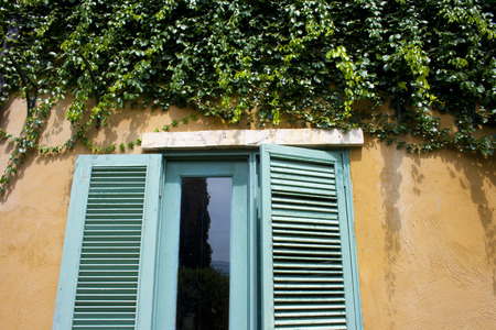 vintage window on color wallの写真素材