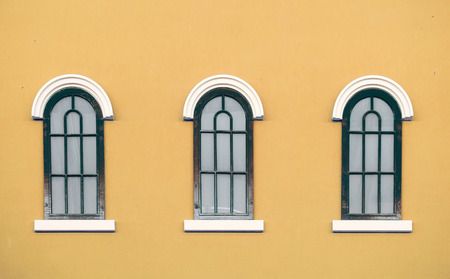 vintage window on color wallの写真素材