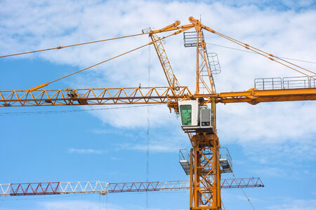 Industrial construction cranes on sky backgroundの写真素材