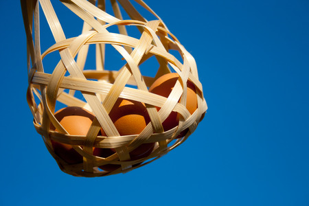 Eggs in basket on blue skyの写真素材