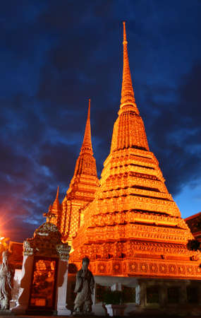 The pagodas of Wat Pho temple at night. Bangkok, Thailandの写真素材