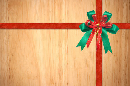 Red Christmas Ribbon on wood backgroundの写真素材
