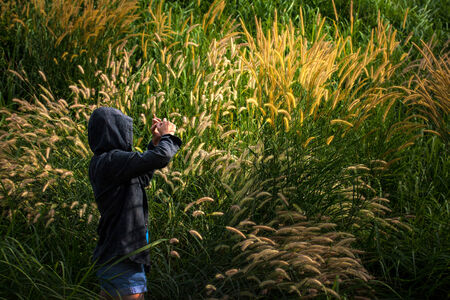 Woman shot in a field of grass.