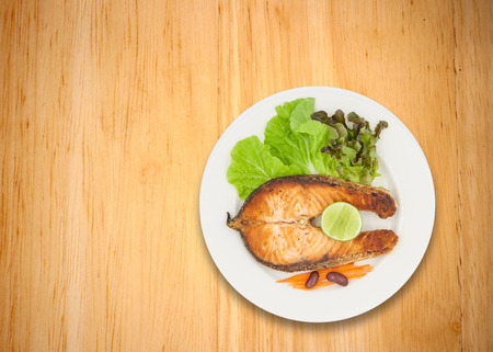 Salmon steak with lemon, bean, carrot, and lettuceの写真素材