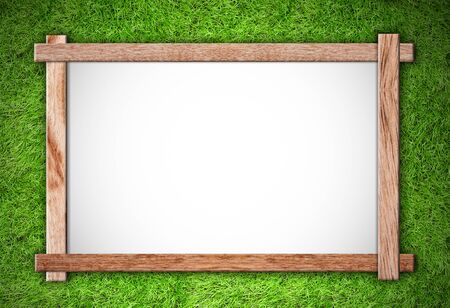 wood frame on green grass backgroundの写真素材