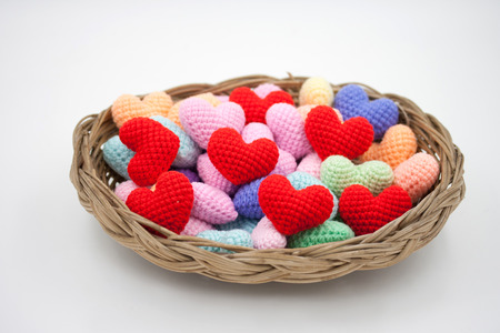 Colorful Yarn hearts in the basket.