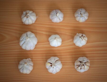 Group of white garlic on wooden backgroundの写真素材