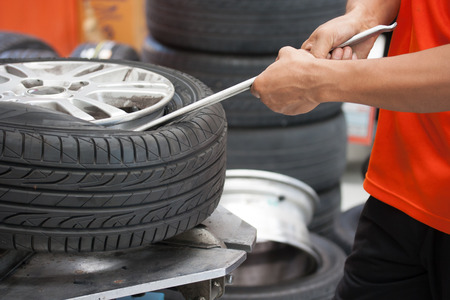 Close-up of Mechanic changing car tire closeupの写真素材