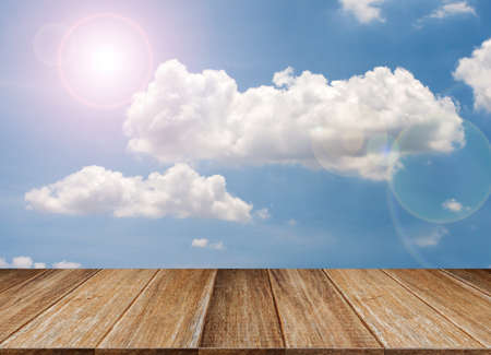 Wood table top on blue sky & cloud background can put or montage your products for display - summer conceptsの写真素材