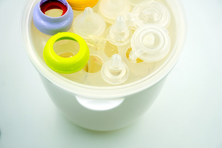 Steaming and sterilizing nipples and milk bottles for babyの写真素材