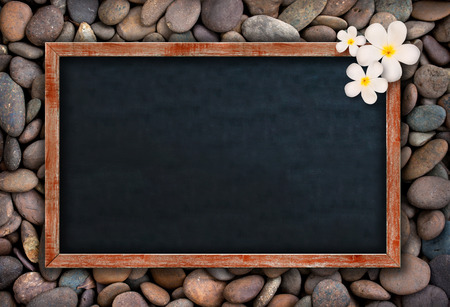 Empty Chalkboard on many rock backgroundの写真素材