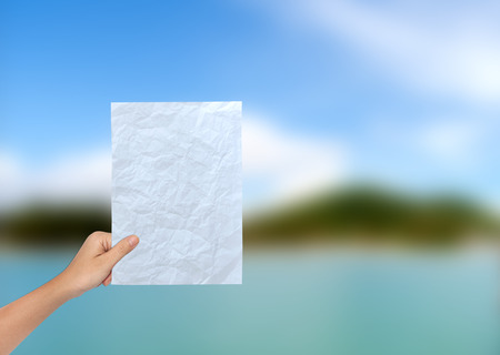 Hand of Female Holding a Blank paperの写真素材