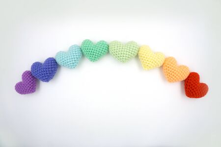 Heart made from yarn laying on a white background.の写真素材