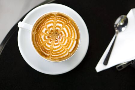 cup of a fresh caramel latte coffee , top viewの写真素材