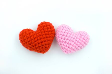 Heart made from yarn laying on a white background.の写真素材