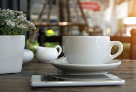 A cup of americano Coffee in coffee shop - vintage and sunlight style effectの写真素材
