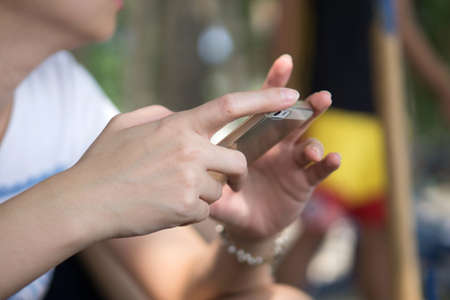 A woman hand holding phone with home  screen pageの写真素材