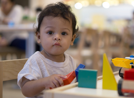 Asian toddler Playing with colorful wooden toys.の写真素材