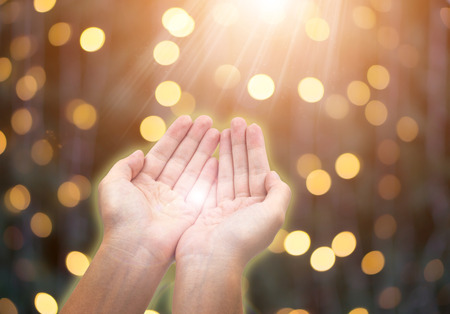 Woman giving or holding hands on celebration bokeh background. Giving concept