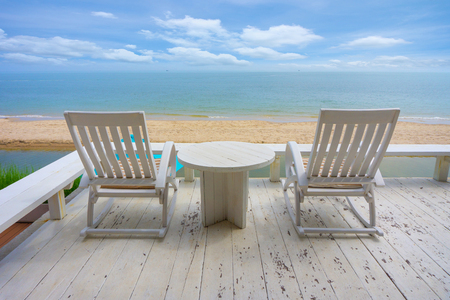 White wood beach chair near sea in summer and relaxing time.の写真素材