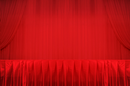 Red curtains and white stage and table.の写真素材
