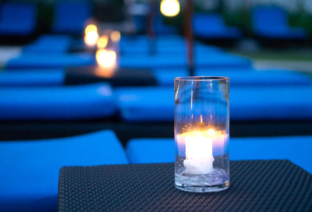 Candle light in glass on black background.の写真素材