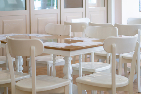 White tables and chairs in a restaurant.の写真素材
